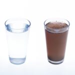 Clean and dirty water in drinking glass – concept