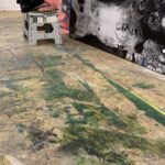 Sora stands on a stepstool to work on details of Verdict