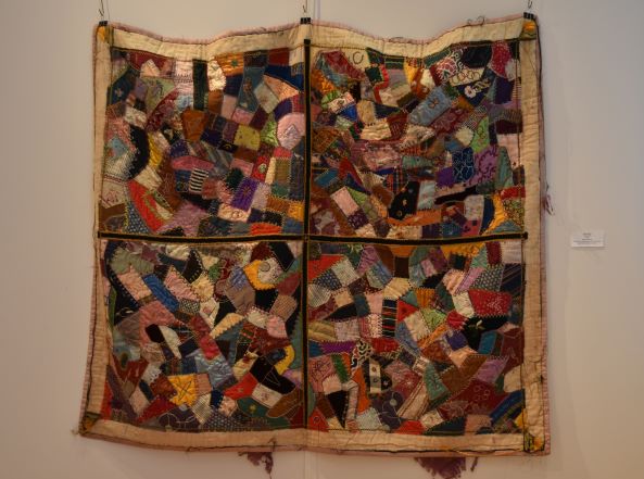 Image: Detail of Crazy Quilt, Anonymous, Undated, textile. An up close look at colorful patchwork with various patterns and shapes. Photo by Kim Kobersmith.