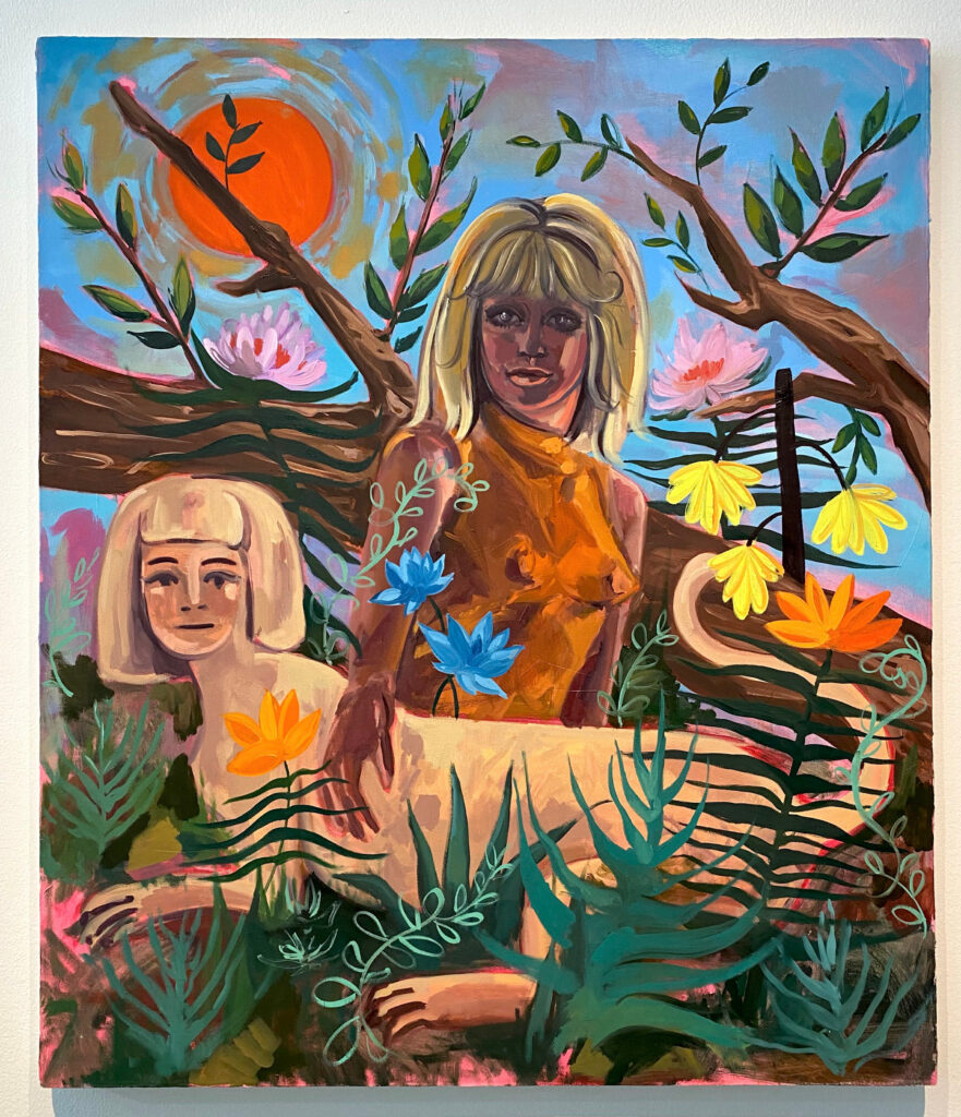 Image: Nikki Woods, Bunny and Sphinx, 2020, oil on canvas. Photo by Ely Maris. A painting of a woman with her hand on a sphinx is hung on a white wall. Flowers and plants surround the two figures, while a bright orange sun sits in the sky.