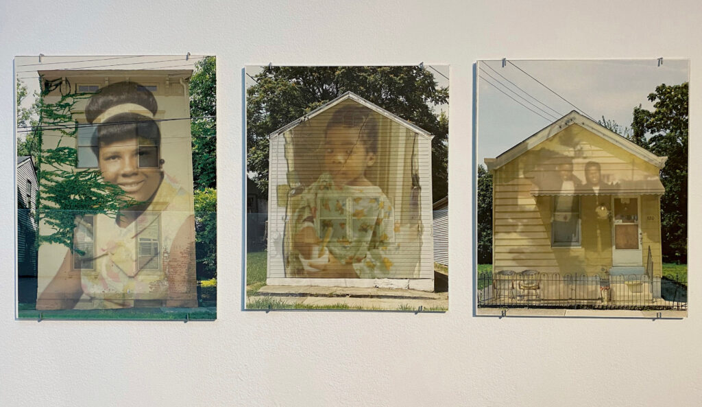 Image: Anissa Lewis: 309 Pleasant Street (Aunt Connie), 2015, digital color print. 310 Pleasant Street (Kris in Hospital Gown), 2015, digital color print. 320 Pleasant Street (Uncle Richard), 2015, digital color print. Photo by Ely Maris. Three photo composites installed on a white wall: The one on the left shows a woman and building, the middle one shows a young boy and a house, and one on the right shows two people and a yellow house.