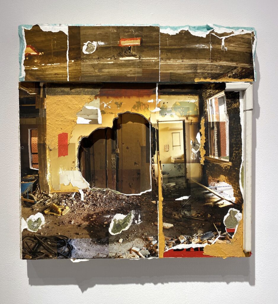 Image: Dereck Mangus, "Johns Hopkins Medical Demolition #1," 2020, digital photomontage on drywall, insulation, wood, found objects, artist papers, deflated balloon, charcoal. A mixed-media, square piece shows the inside of a dilapidated building. The composition is mostly brown and yellow. Photo of artwork by the author.