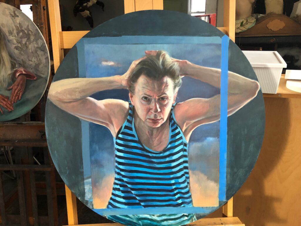 Image: Gaela Erwin, Covid Self-Portrait, 2020, oil on panel, 30" in diameter. A painting depicting the artist with her hands behind her head. She is wearing a black and blue striped tank top. Photograph by Peter Morrin.