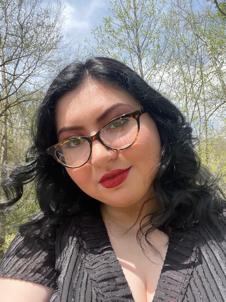 Image: A photo of Tiffany Pyette, Letcher County, who is a two-spirit artist, writer, activist, and grant recipient from the Waymakers Collective. She has black hair and glasses and looks straight at the viewer. Image courtesy of the artist.