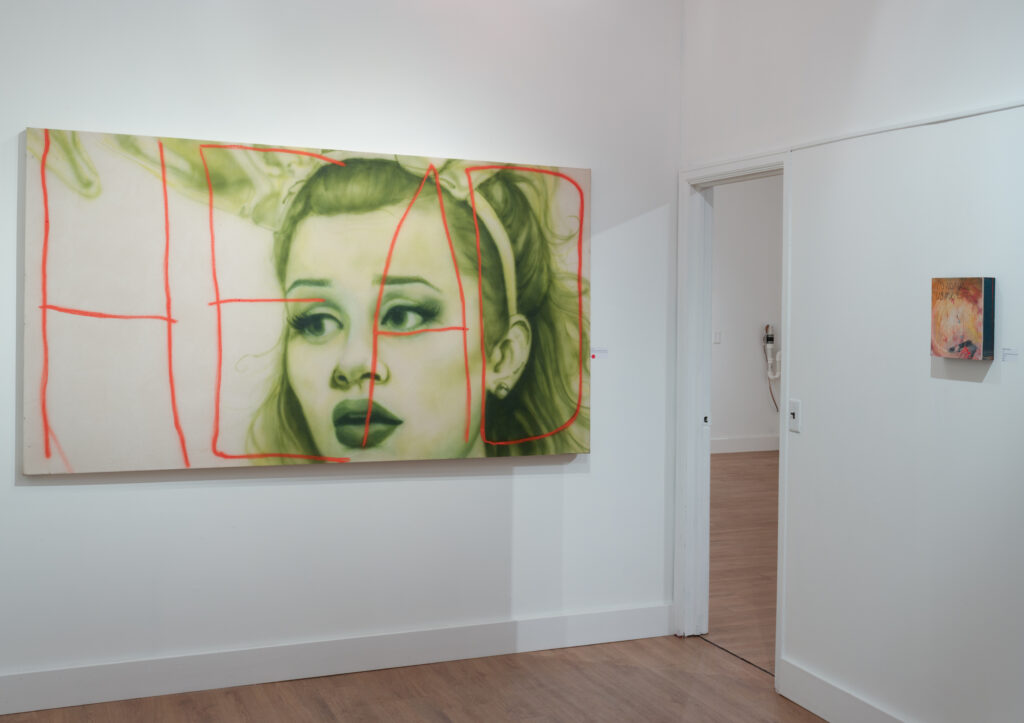 Image: An installation view of Wow, Nice. at Racecar Factory gallery. On the left hangs the piece You do know how to whistle, don't you? by Liza Jo Eilers, and to the right hangs the piece :*( by Madeline Norton. Image courtesy of the gallery.