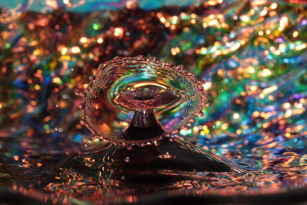 Image: Aura (Gentle Breeze) by Mark Lenn Johnson. This piece is part of the artist's “Fountainfalls” photography series, in which he uses a high-speed camera to capture drops of liquid as they fall into a bowl of water with his own glass bowls as colorful backgrounds. Image courtesy of the artist.