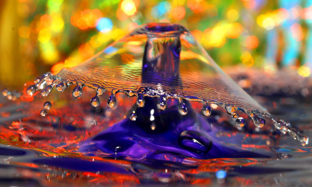 Image: Mark Lenn Johnson, Dayo - Joy Arrives (African). This piece is part of the artist's “Fountainfalls” photography series, in which he uses a high-speed camera to capture drops of liquid as they fall into a bowl of water with his own glass bowls as colorful backgrounds. Image courtesy of the artist.
