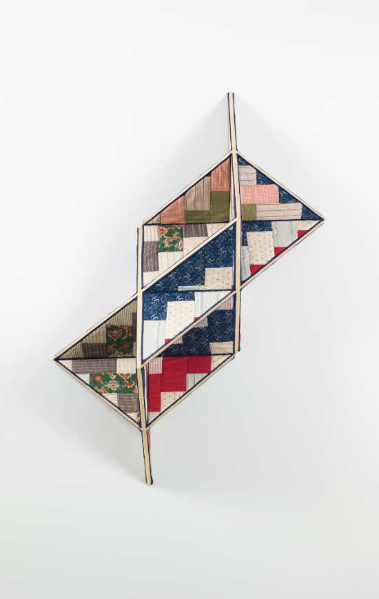 Image: Sanford Biggers, Incidental Geometry, 2017. Antique quilt, birch plywood, gold leaf. 48h x 17w x 22d in. © Sanford Biggers and Marianne Boesky Gallery. Photograph by Object Studies. A multicolored quilt piece structured on wood so that it takes on a three-dimensional, geometric shape.