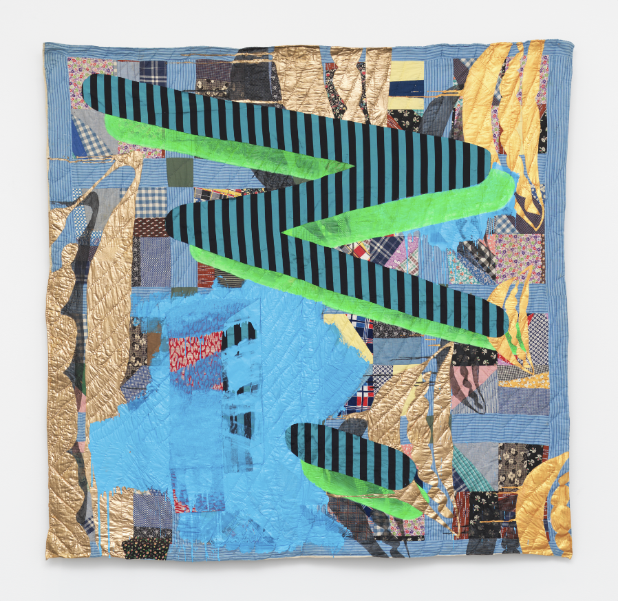 Image: Sanford Biggers, Chorus for Paul Mooney, 2017. Antique quilt, assorted textiles, acrylic, spray paint. Top: Dibond, 75.5 x 5 in., ssbquilt091. © Sanford Biggers and Marianne Boesky Gallery. A quilted piece hanging on the wall with abstract organic and geometric shapes of mostly bright blue and gold.