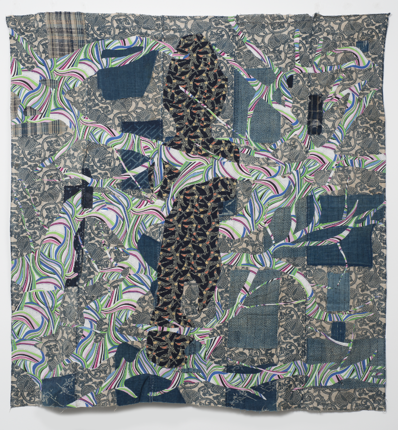 Image: Sanford Biggers, Beloved, 2017. Antique futon cover, assorted textiles. 65 x 62 in., ssbquilt069. © Sanford Biggers and Marianne Boesky Gallery. A photo of a contemporary quilt piece with organic patterns in shades of blues, blacks, and tans. More colorful branch-like shapes expand across the composition.