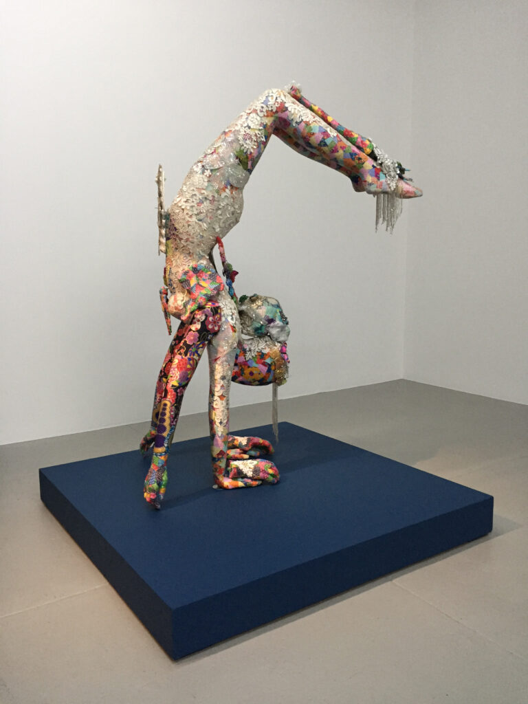 Image: Saya Woolfalk, ChimaCloud Crystal Body B, 2017. Mixed Media. A colorful sculpture resembling a figure doing a handstand. Courtesy of 21c Museum Hotel, Nashville.