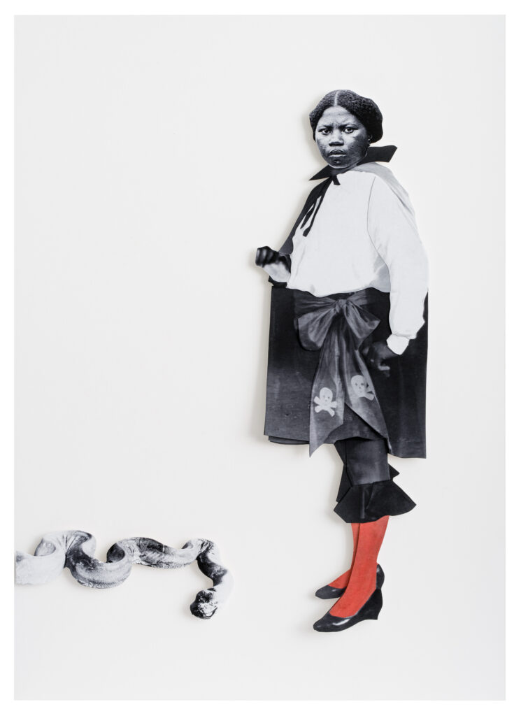 Image: Frida Orupabo, Woman with Gun, 2021. Collage with paper pins. A woman stands and turns as she looks towards the viewer. A snake lies at her feet. The composition is black and white with the exception of her red tights. Courtesy of 21c Museum Hotel, Nashville.